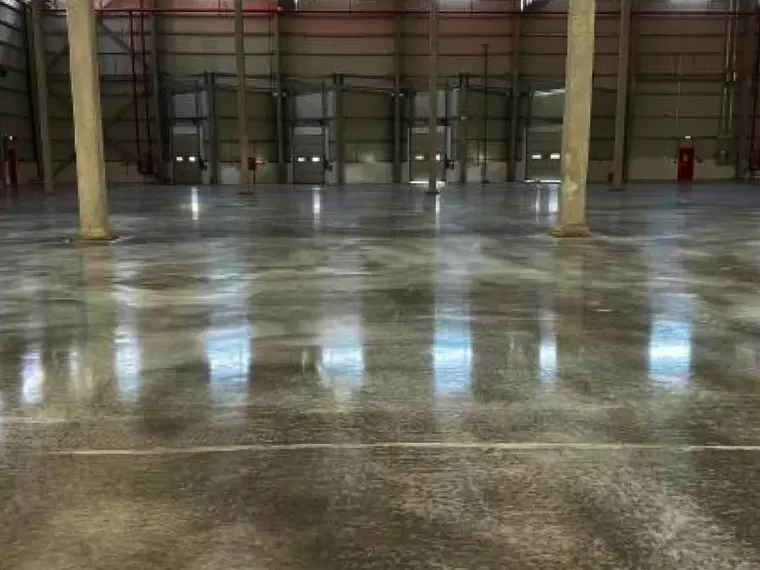 Polished concrete floor running the length of a warehouse bay